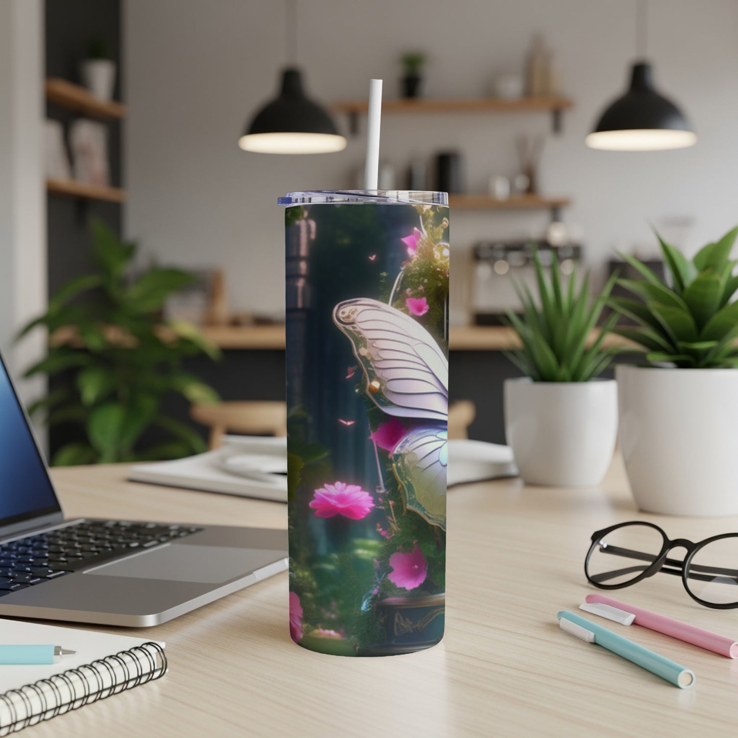 Tall tumbler with butterfly wings and pink flowers against a blurred background.