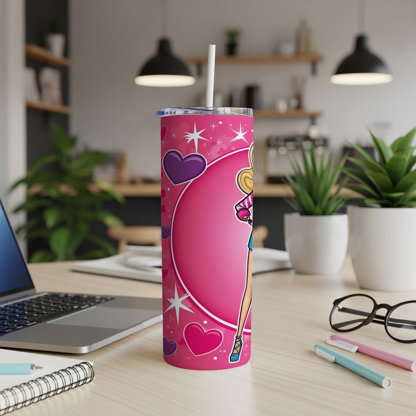 Pink tumbler with Barbie illustration and hearts, on a desk.