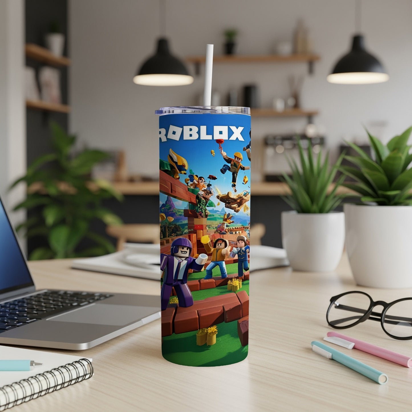 Roblox themed tumbler with cartoon characters and straw, on a desk.