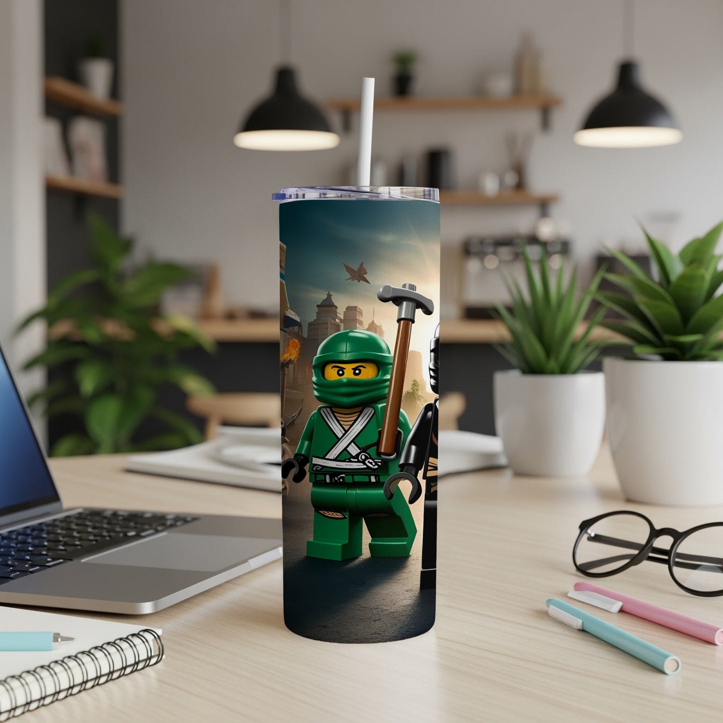 Green Lego ninja with sword and axe, holding a tumbler on a desk.