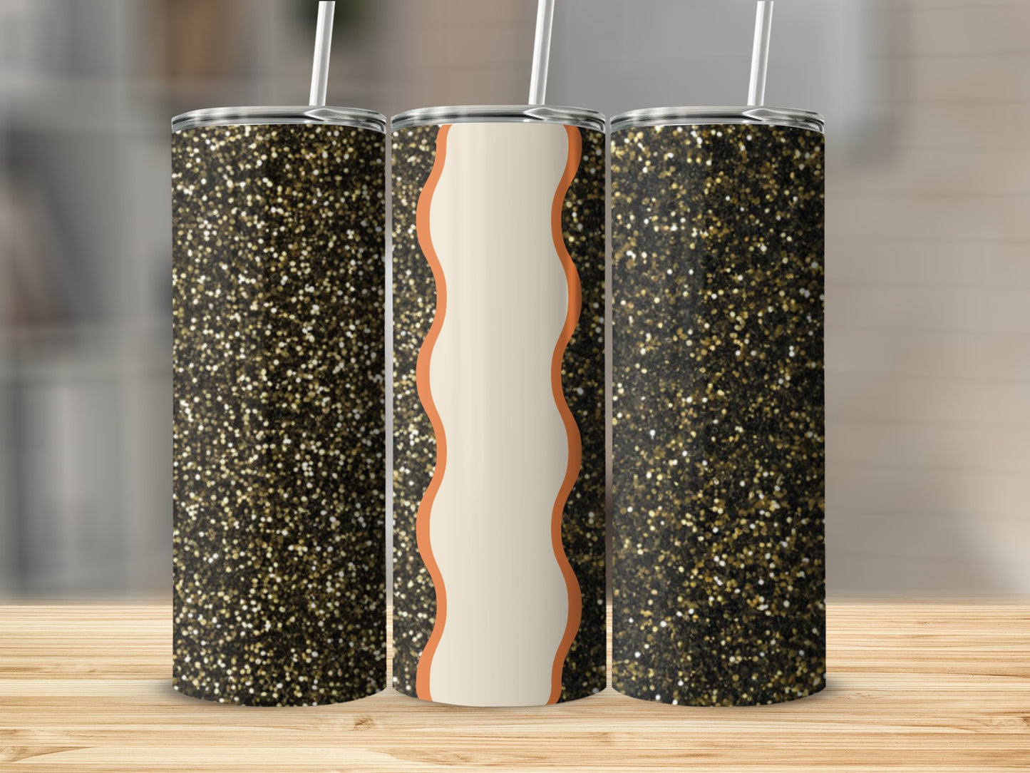 Three glitter tumblers with straws on a wooden surface.