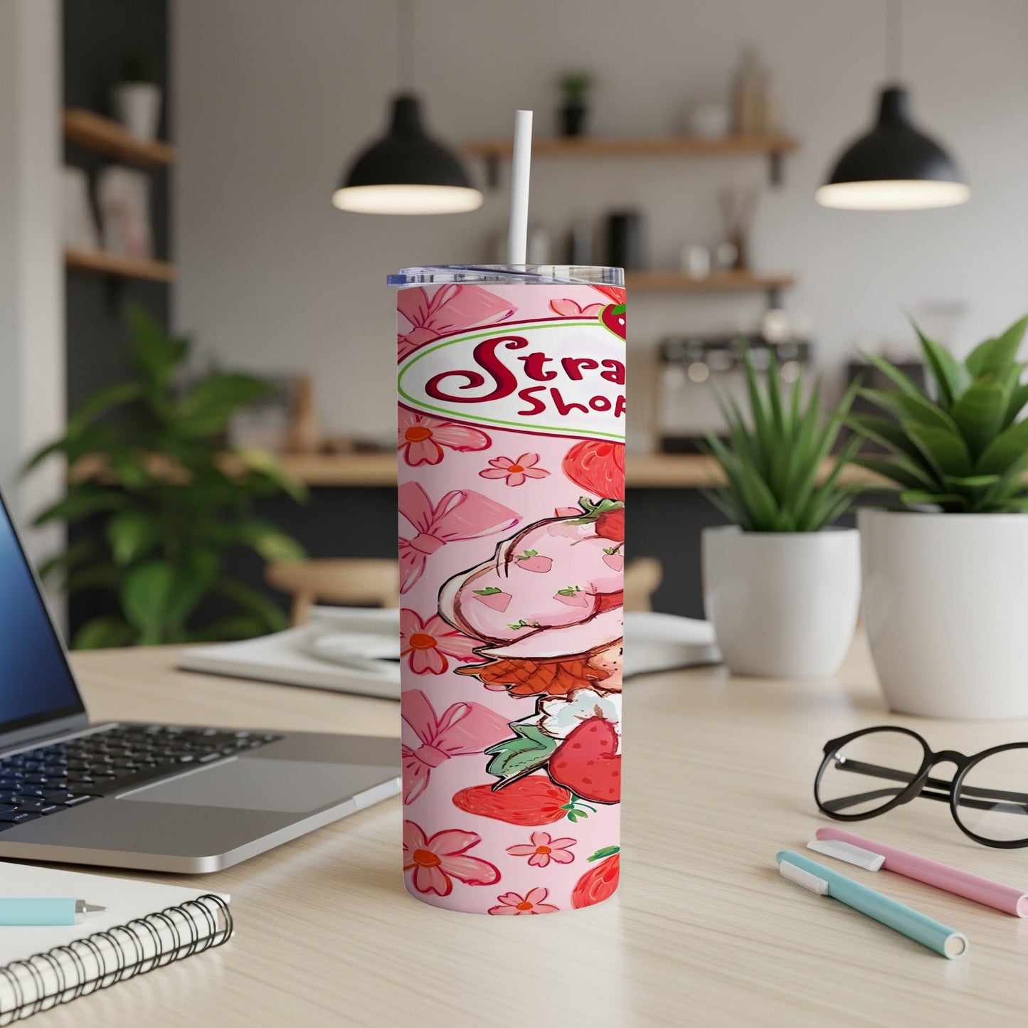 Strawberries and floral pattern on a pink skinny tumbler with straw.