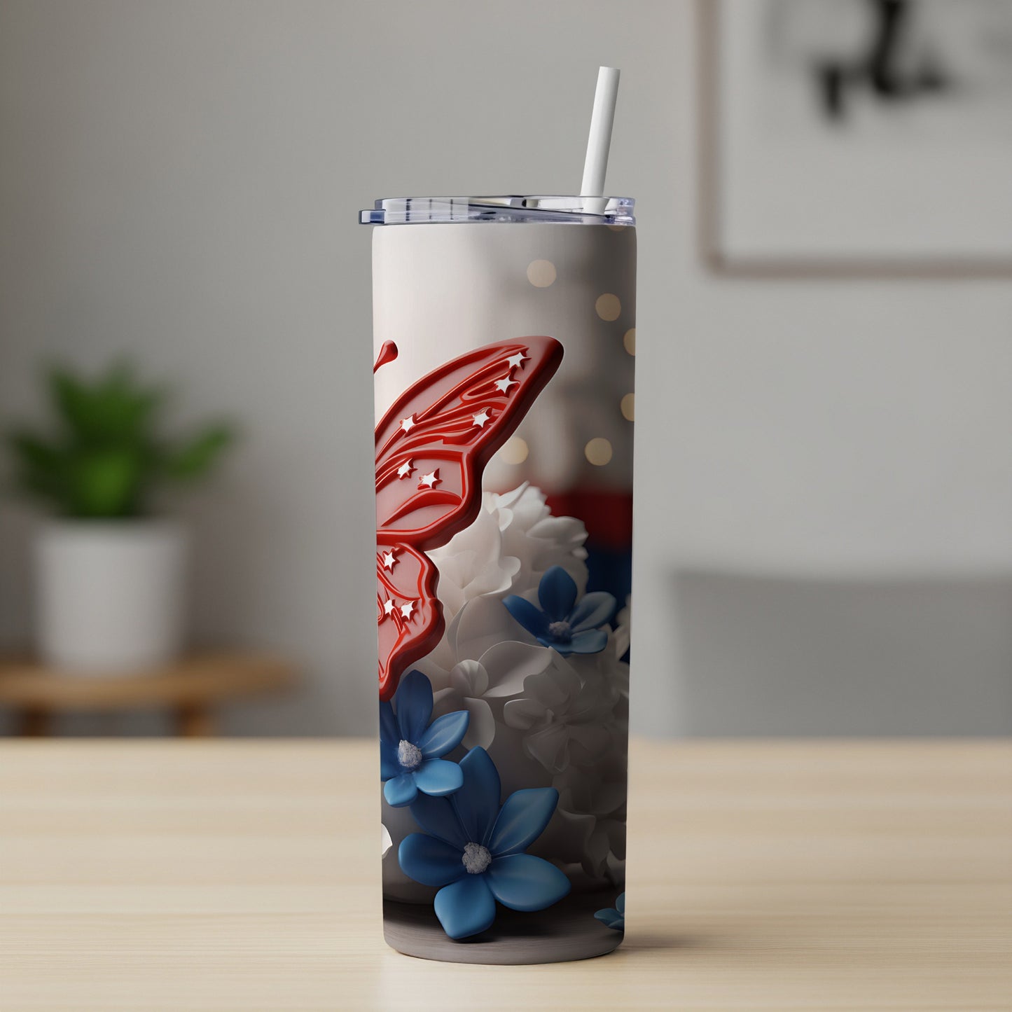 Tumbler with red butterfly and blue and white flowers.