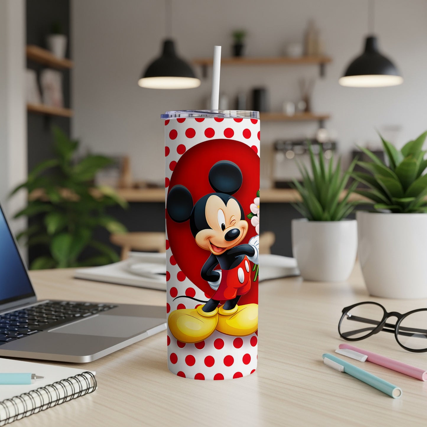 Mickey Mouse in red polka dots on a white tumbler with a straw.