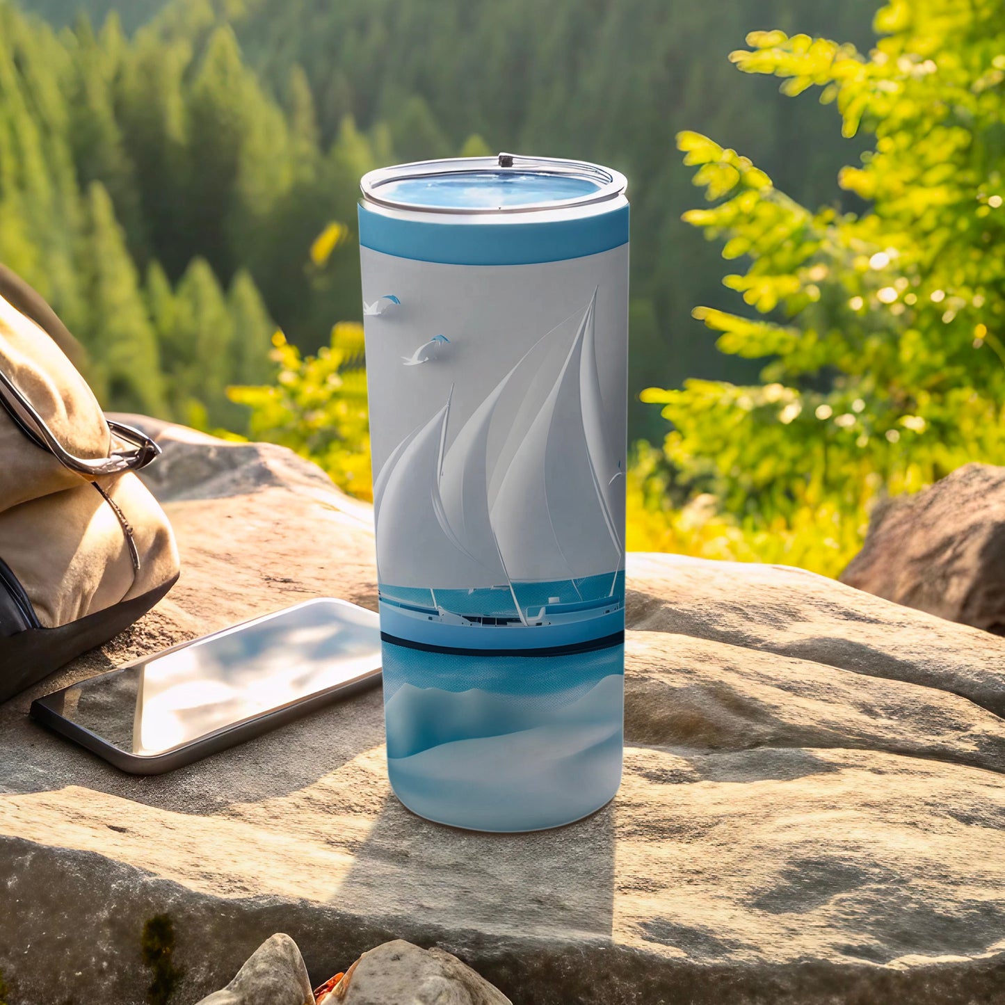 Blue tumbler with sailboat graphic and seagulls on rocky outcrop.
