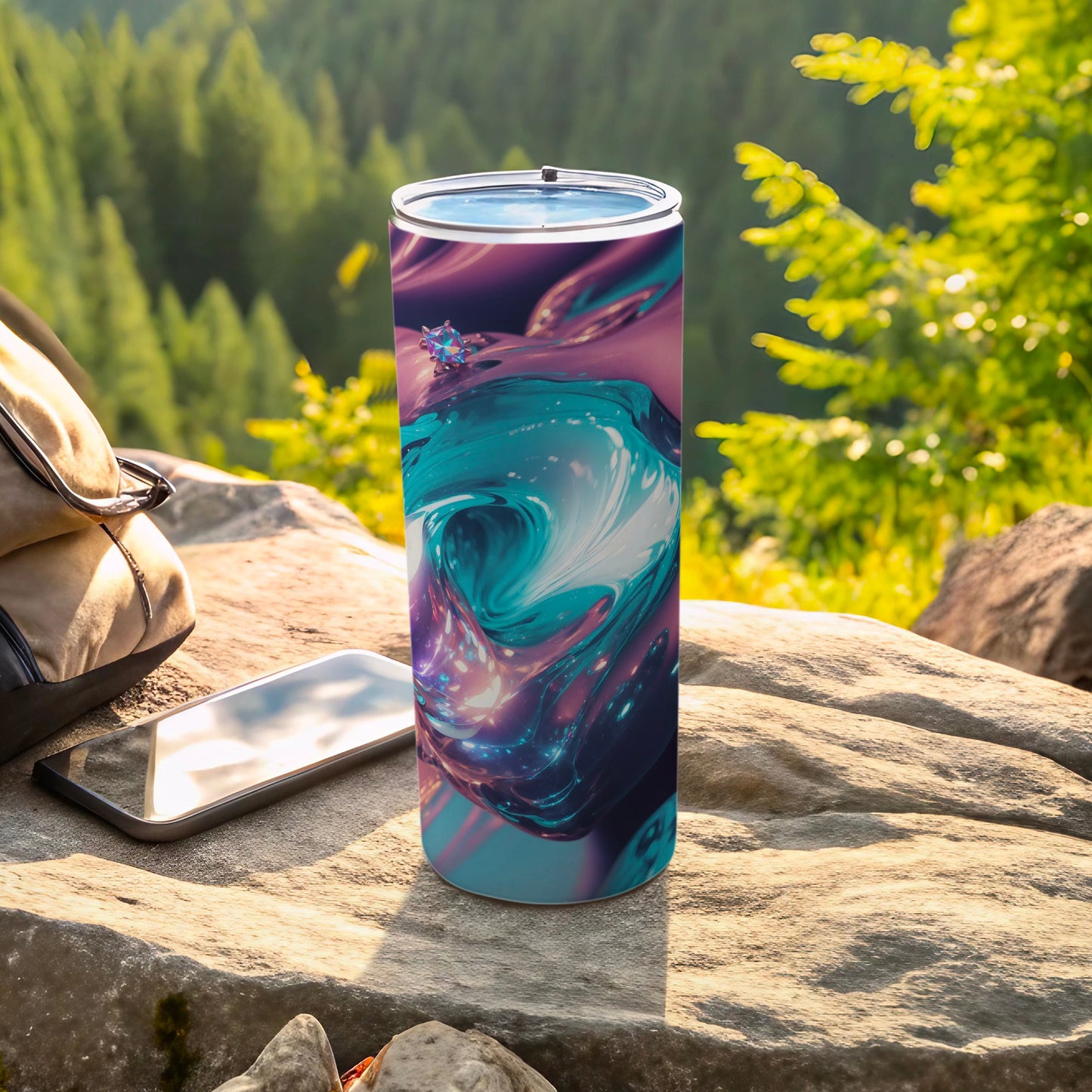 Tall tumbler with swirling blue and purple abstract design outdoors on a rock.