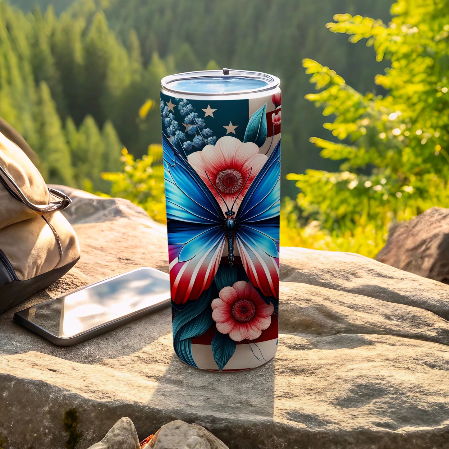 Tumbler with patriotic butterfly and floral design outdoors.