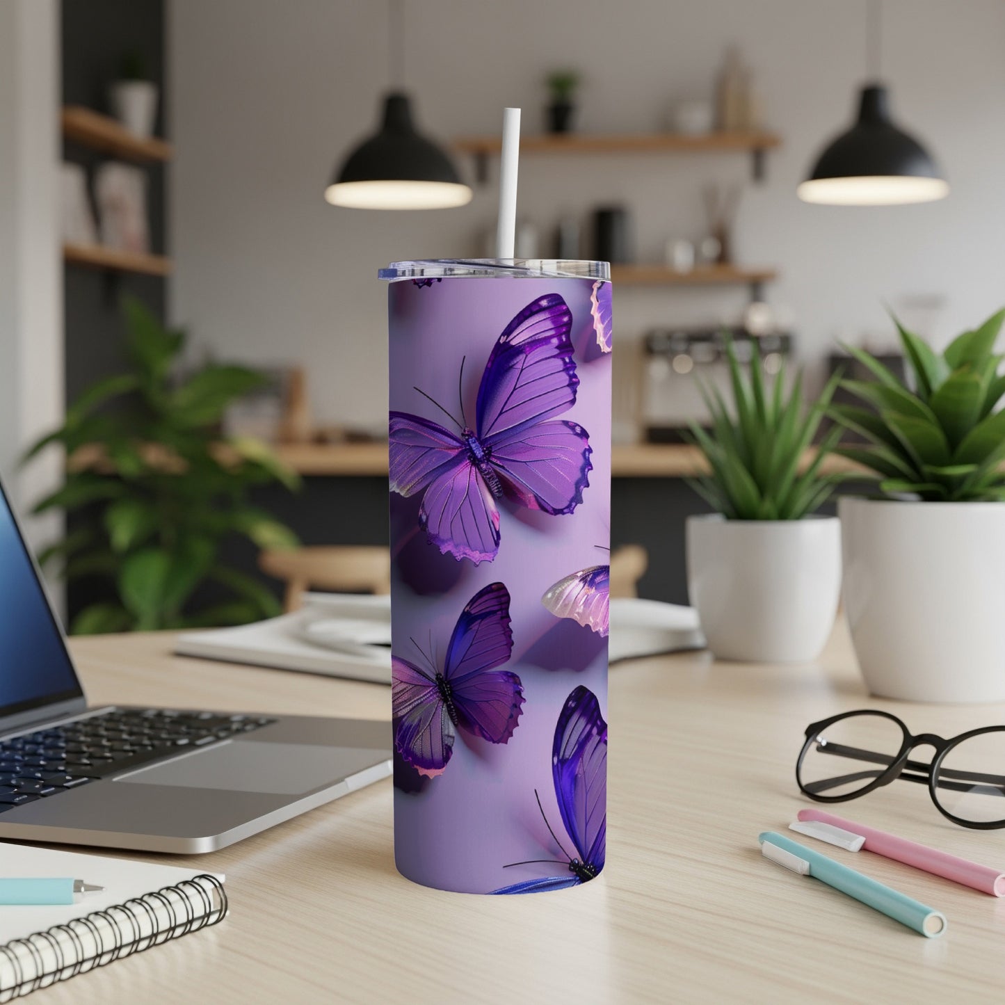 Purple butterflies on a lilac tumbler with a straw, on a desk.