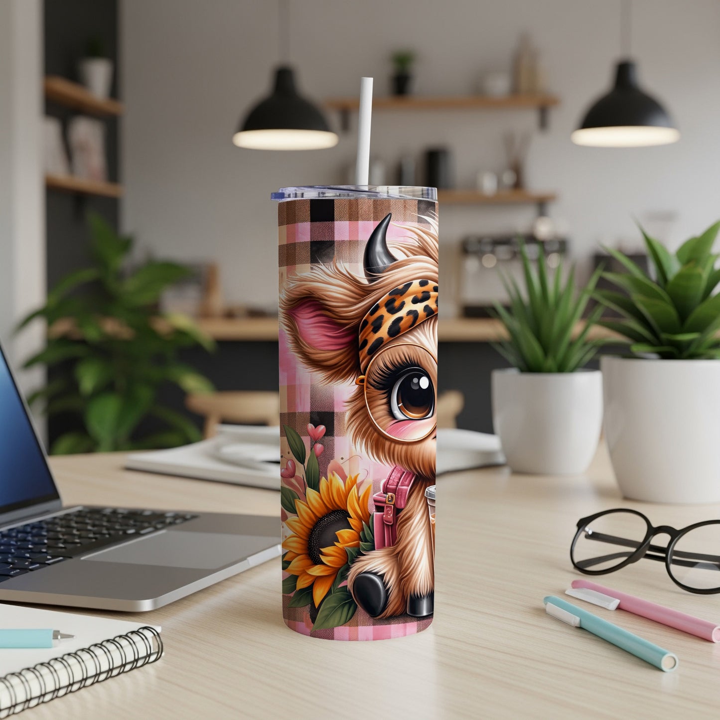 Pink plaid tumbler with a cartoon cow and sunflower design.