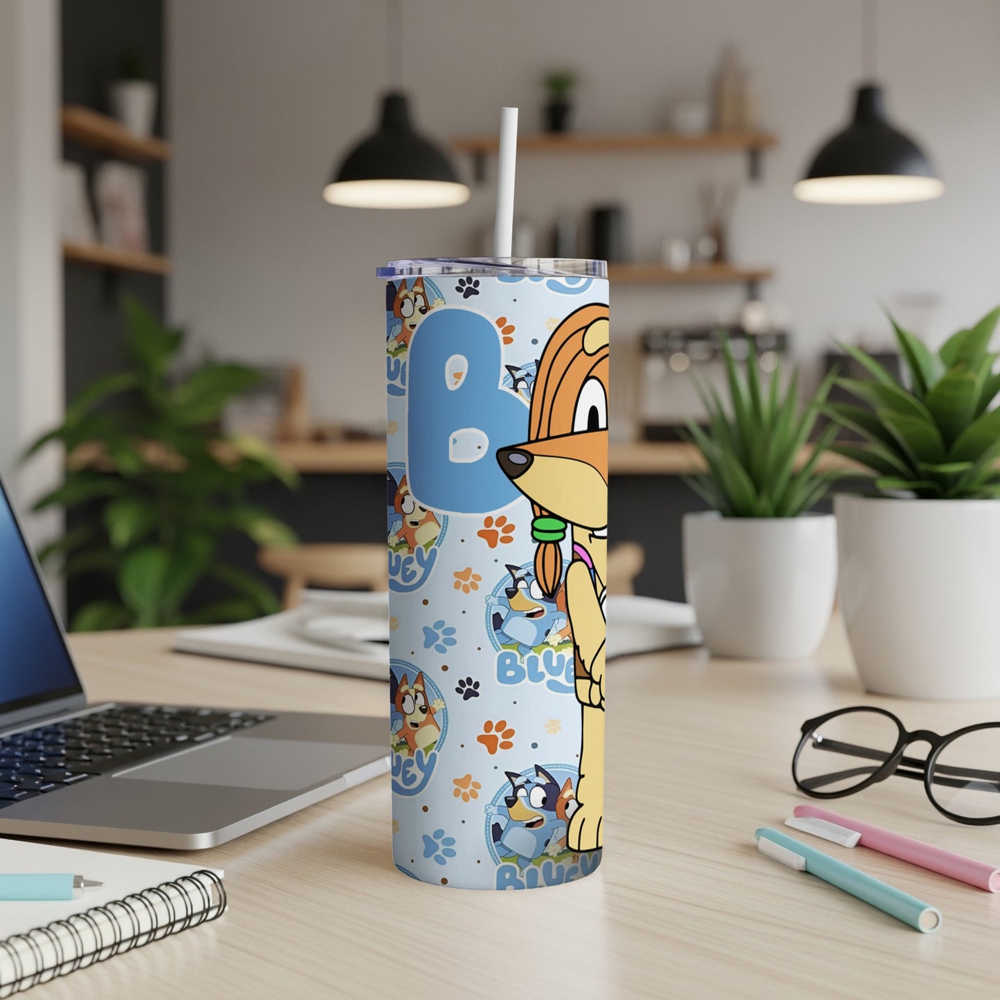 Bluey character tumbler with straw on a desk.