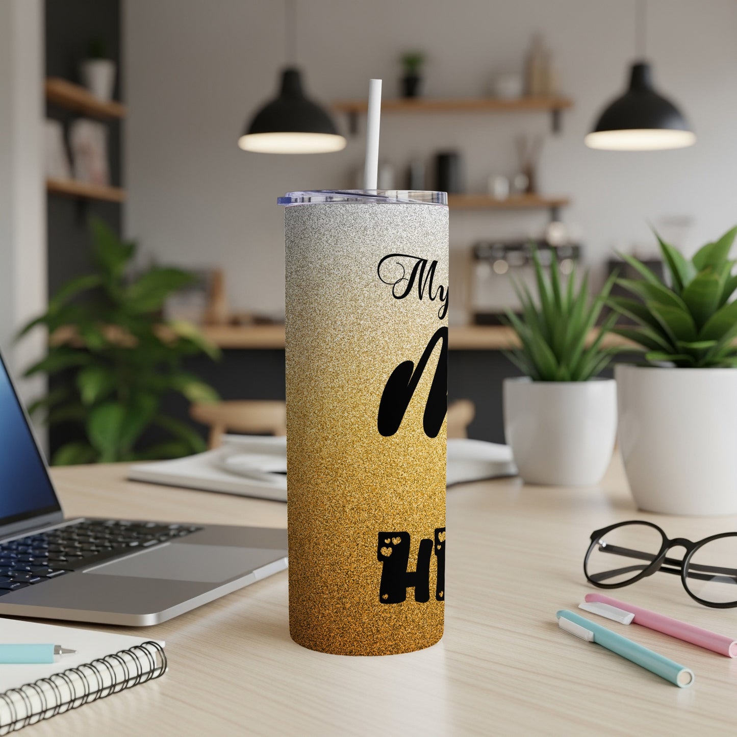 Glitter tumbler with "My favorite people call me" text on a desk.