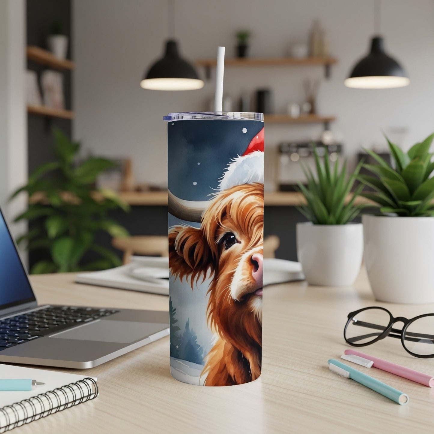 Highland cow in Santa hat on a festive blue and white tumbler.