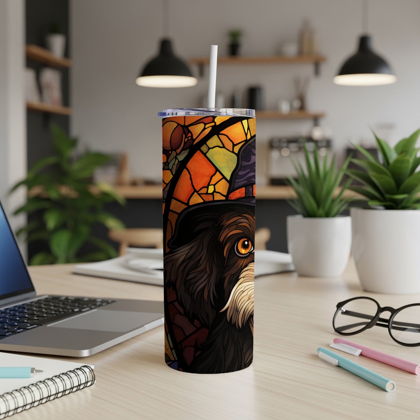 Stained glass dog wearing a hat on a tumbler with a straw.