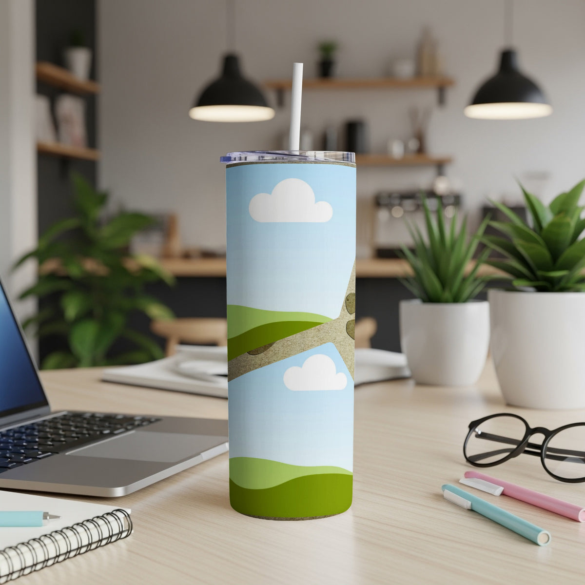 Tumbler with clouds, green hills, and a tree branch design.