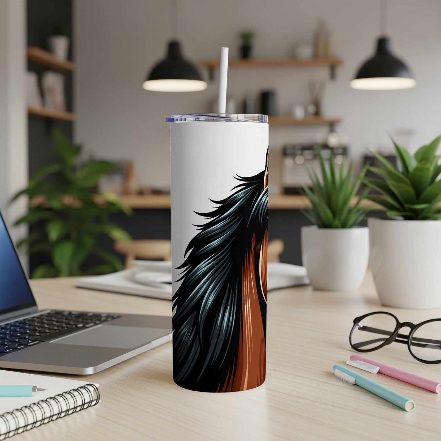 White tumbler with horse mane illustration on a desk.