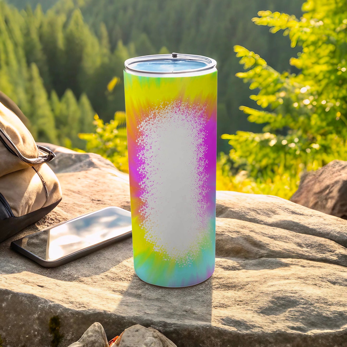 Tie-dye tumbler with blank white space for personalization outdoors.