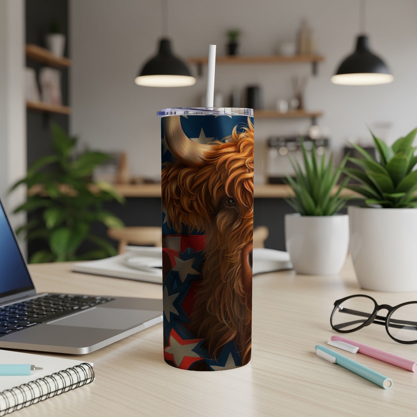 Highland cow with American flag design on a tumbler.