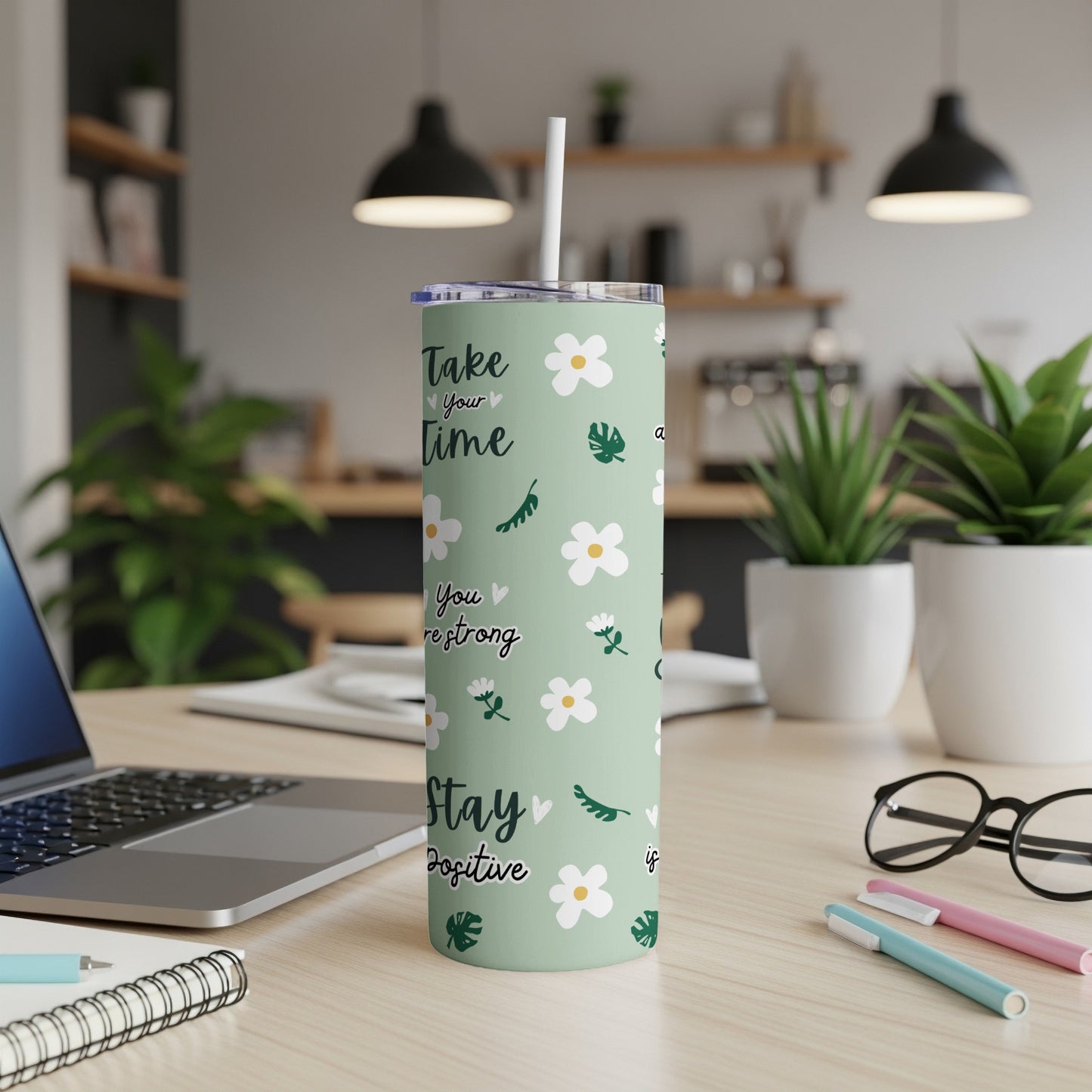 Green tumbler with floral pattern and inspirational text, "Take time to love yourself, stay positive."