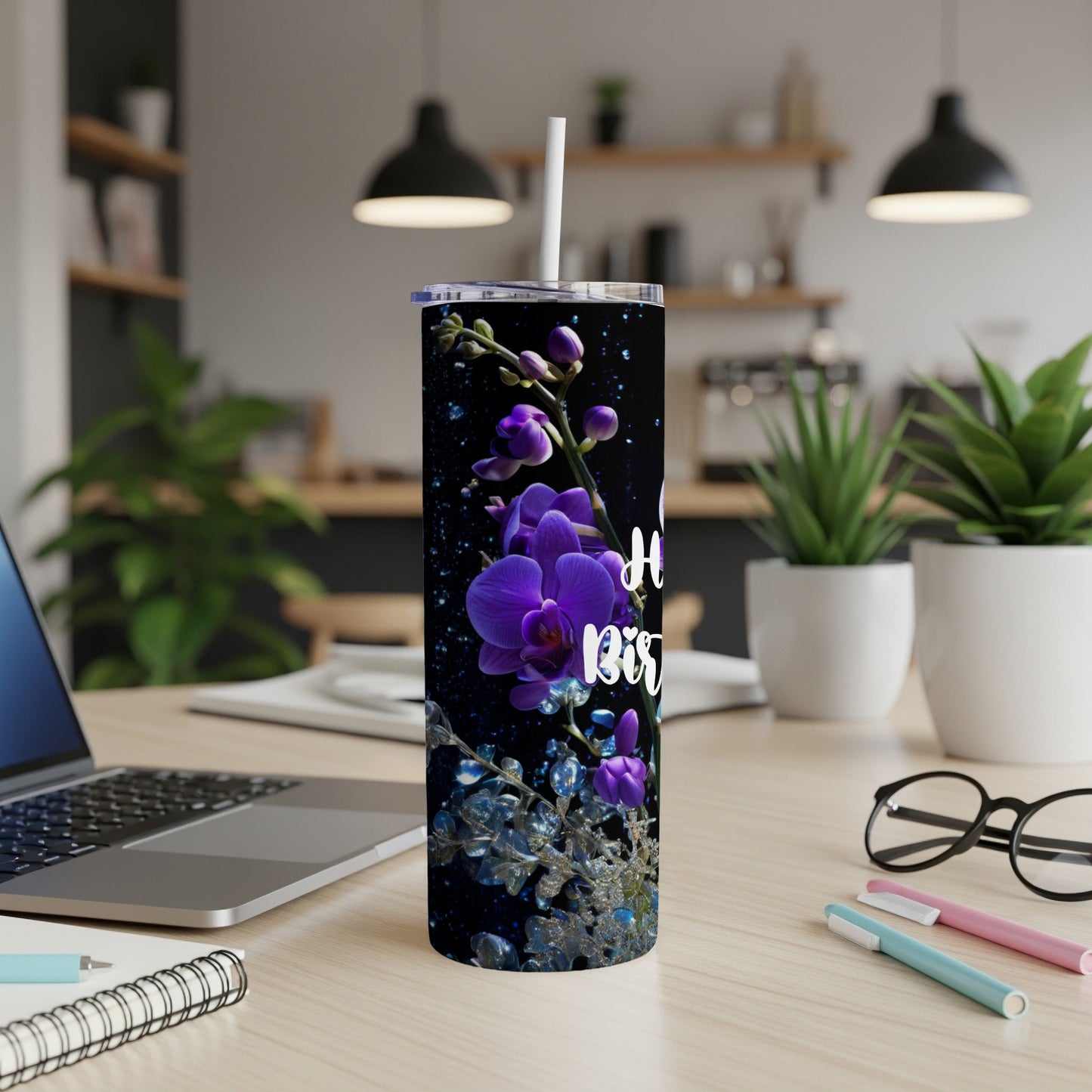 Purple orchid and glitter design on a tall tumbler with a white straw.