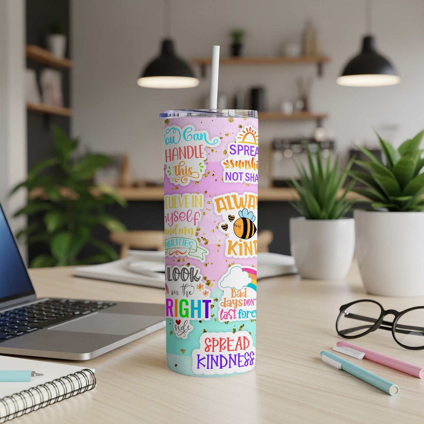 Tumbler with colorful text and graphics, "Spread Kindness" prominent.