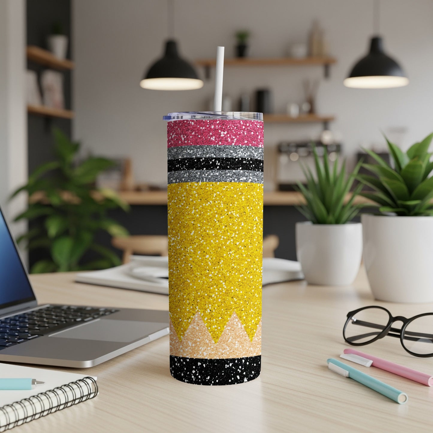 Yellow glitter tumbler with pink, black, and white accents, featuring a straw.