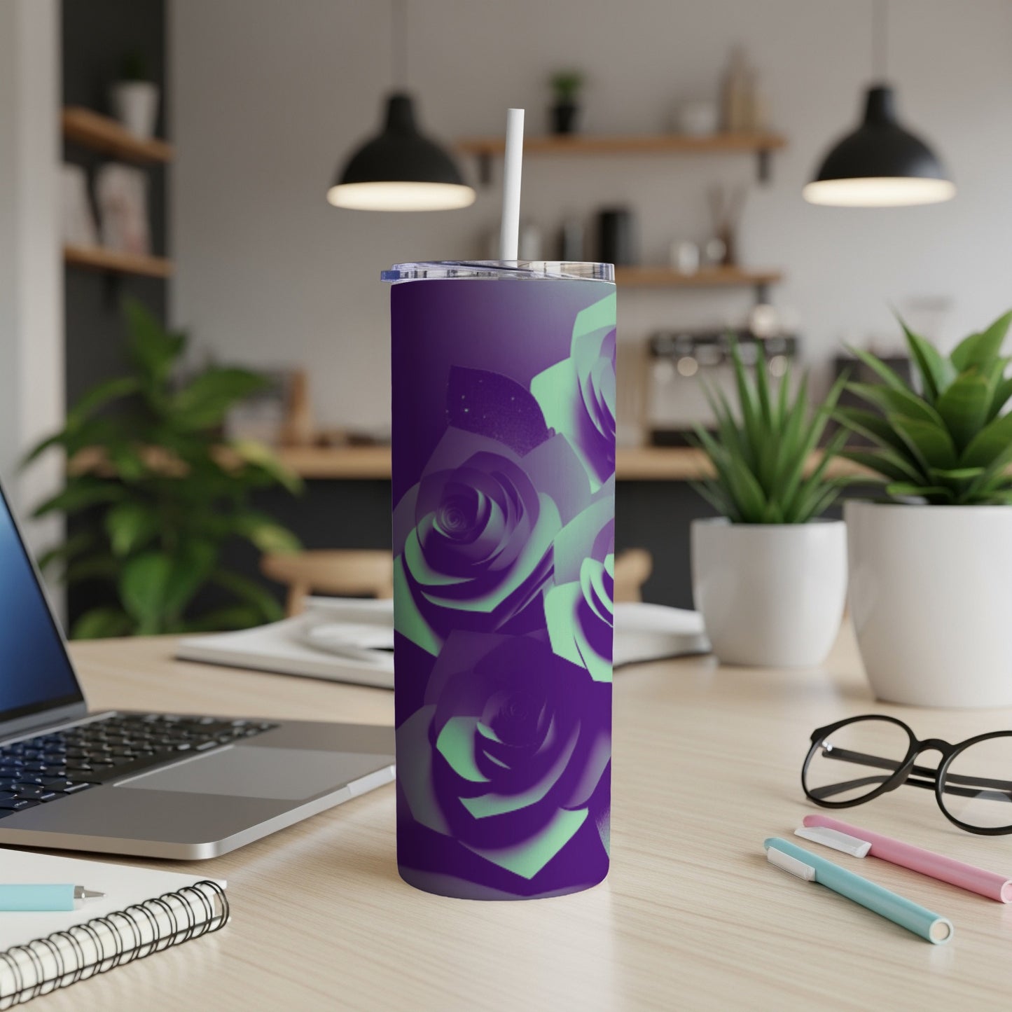 Purple tumbler with gradient green roses and white straw on a desk.