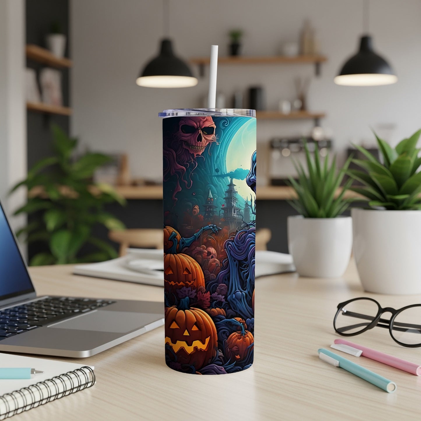 Halloween tumbler with a spooky scene of skulls, pumpkins, and haunted houses.