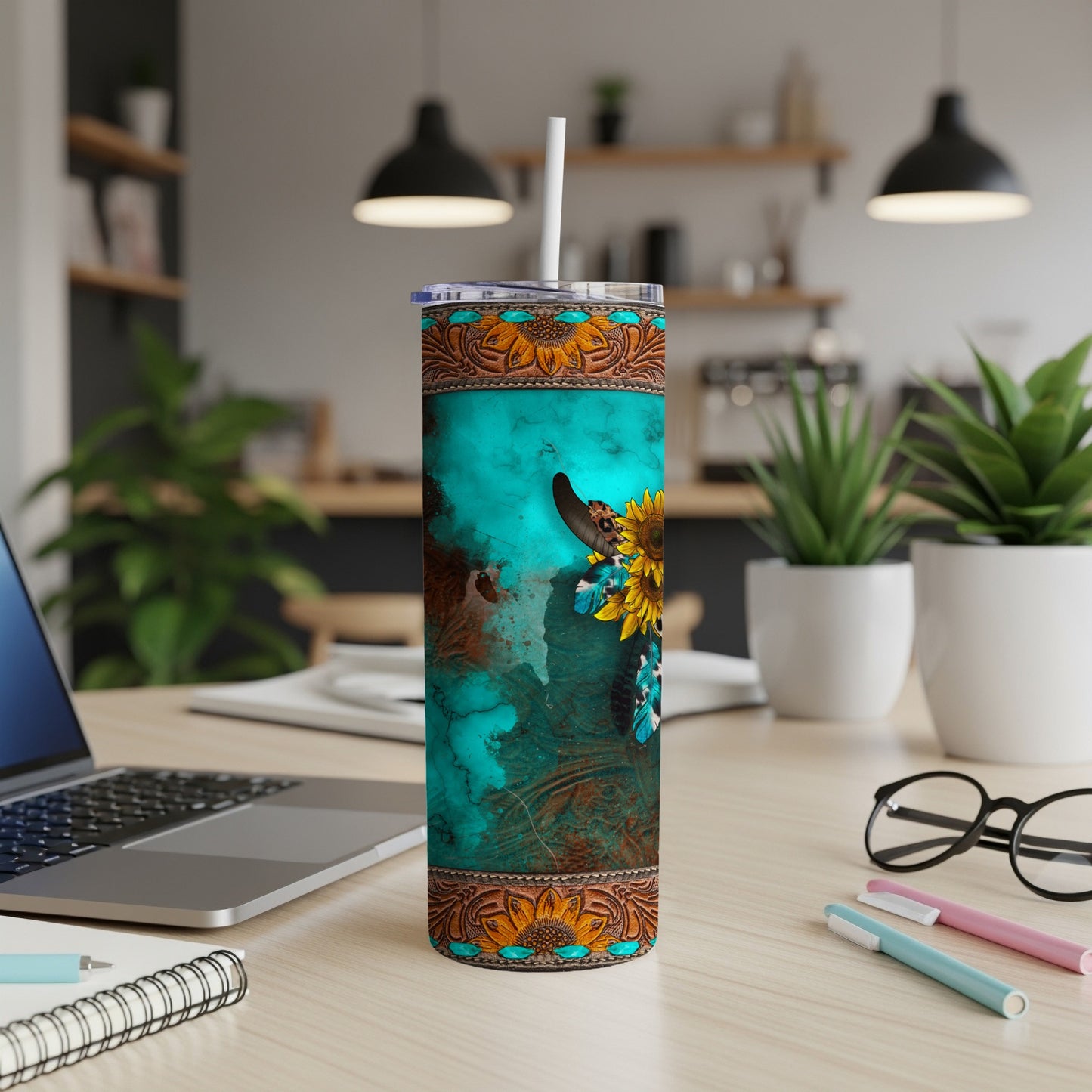 Turquoise tumbler with cow skull, sunflowers, and western patterns.