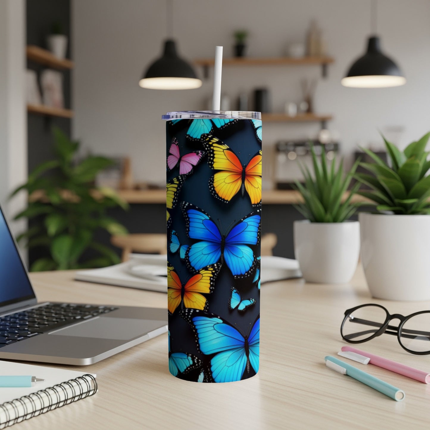 Tall tumbler with colorful butterflies on a dark background.