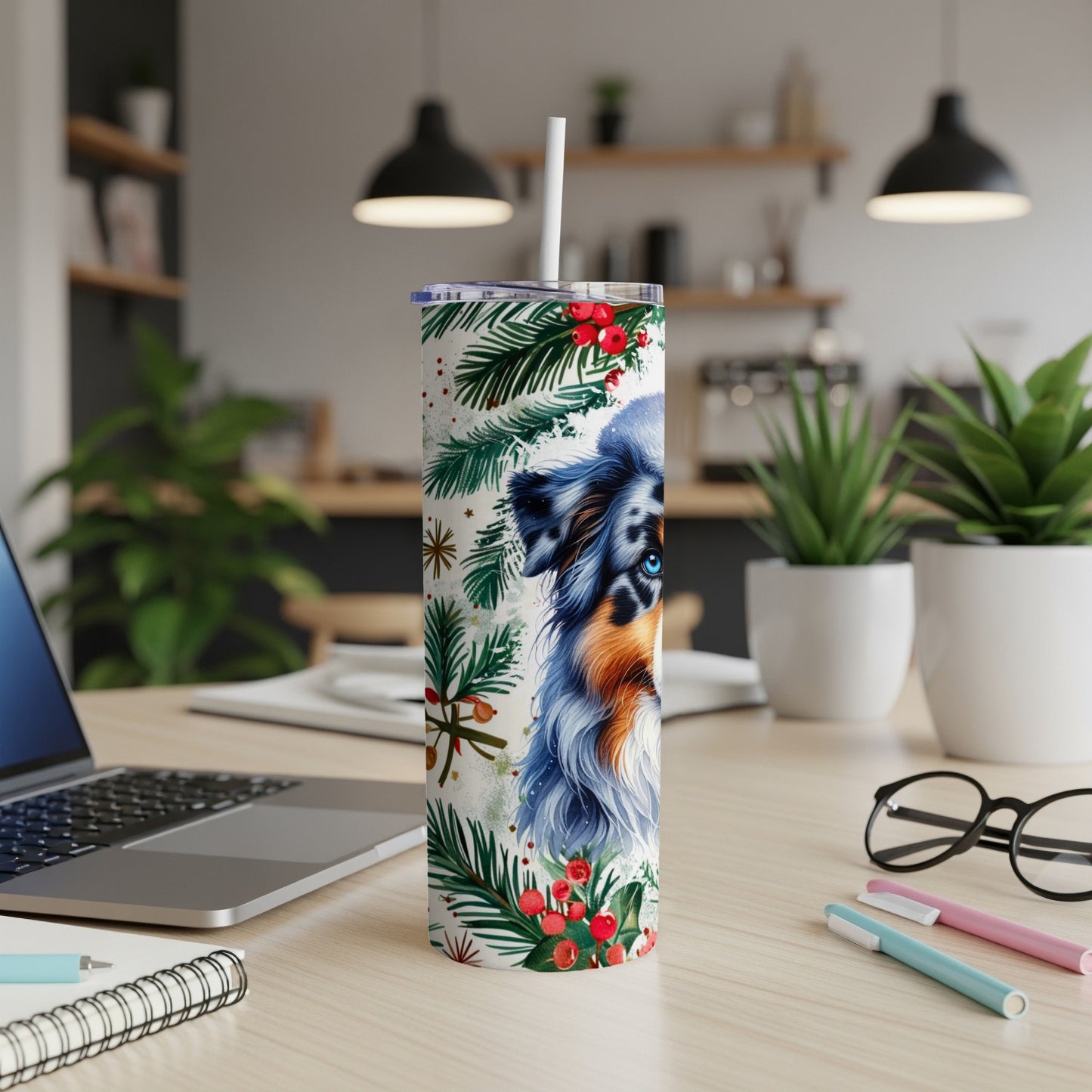 Blue merle Australian Shepherd on a Christmas-themed tumbler with straw.