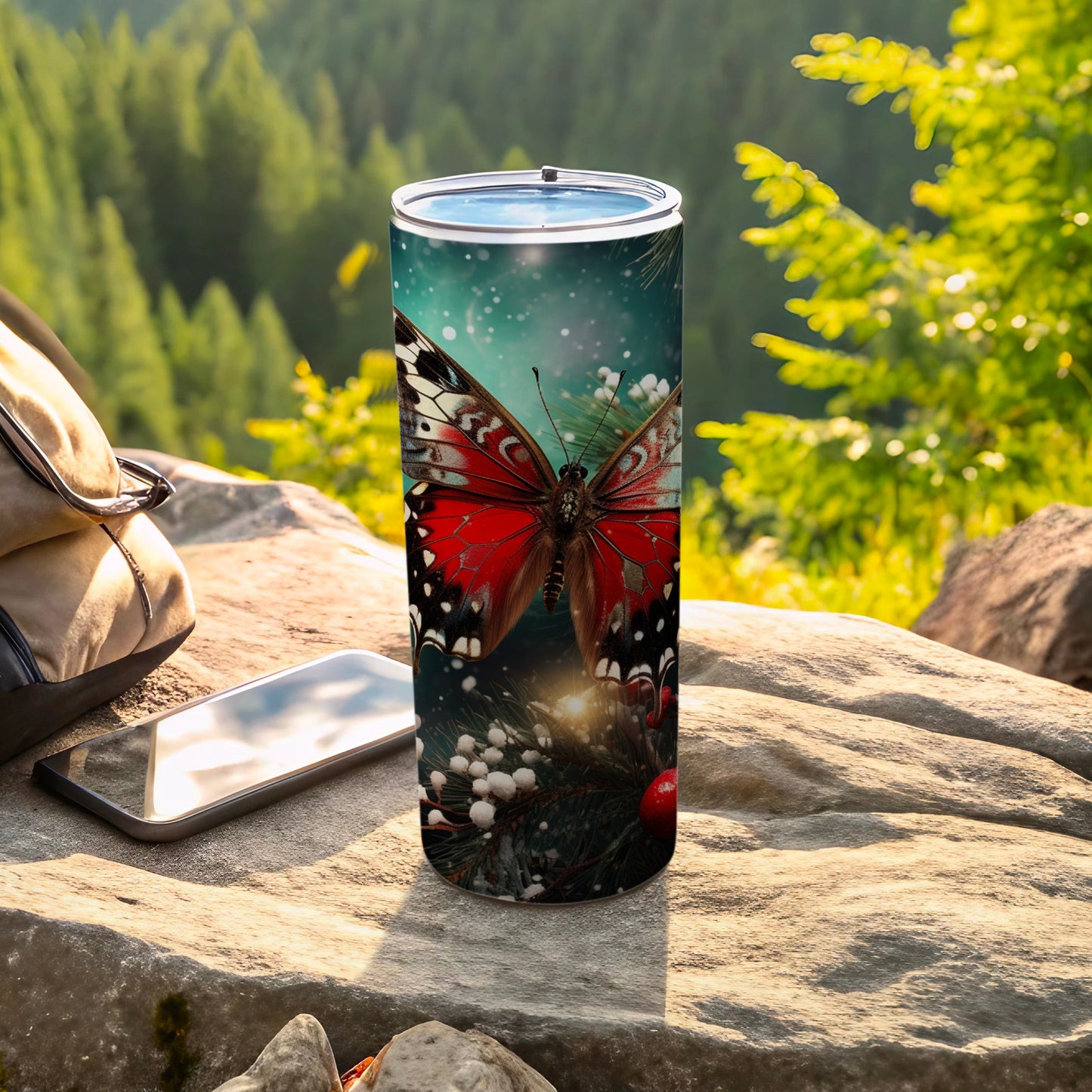 Red butterfly design on a stainless steel tumbler with pine branches.