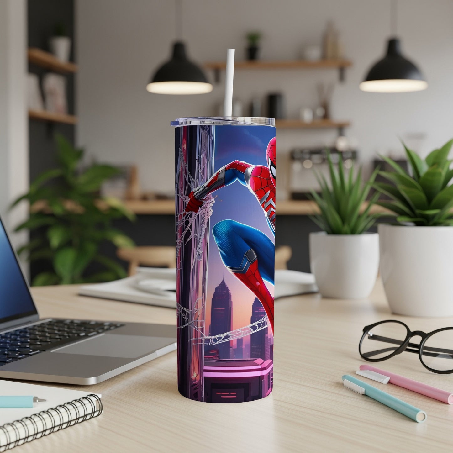 Spider-Man on a cityscape tumbler with a straw, on a desk.