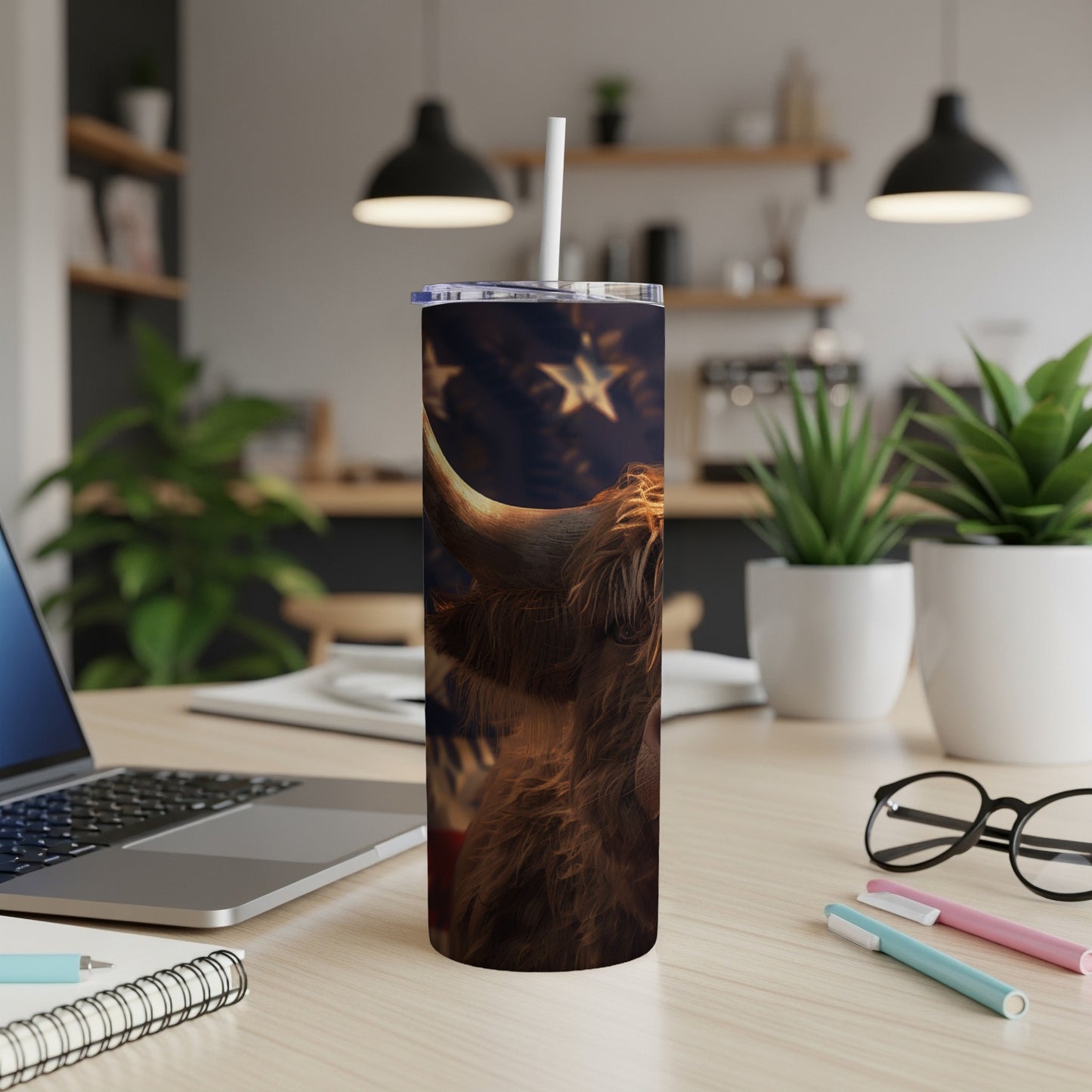 Highland cow with American flag pattern on a tumbler with a straw.