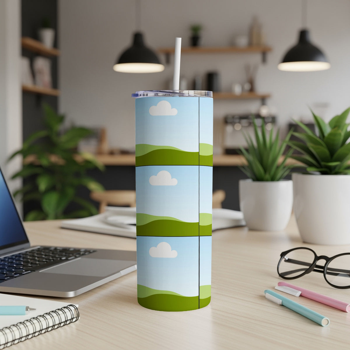 Tall tumbler with three stacked landscape images and a white straw.