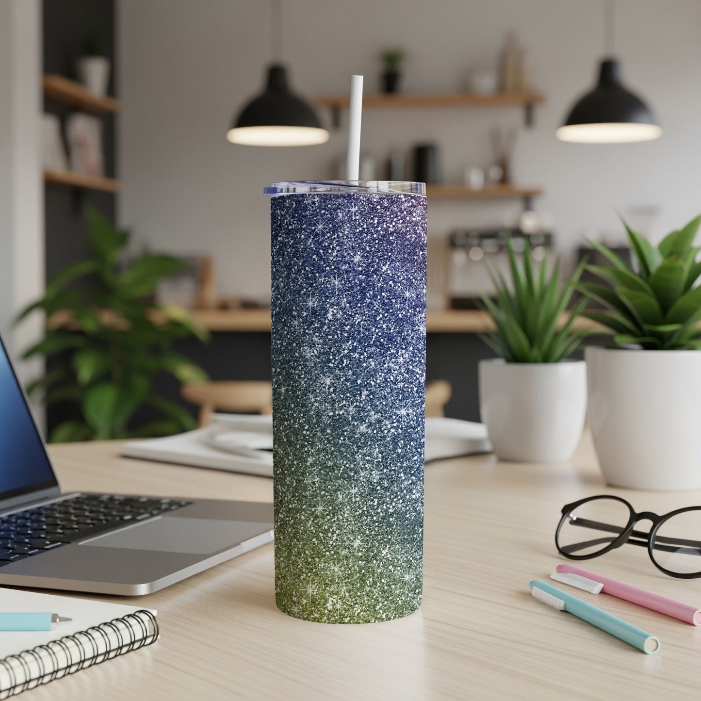 Glitter tumbler with blue to green gradient, white straw, and lid.