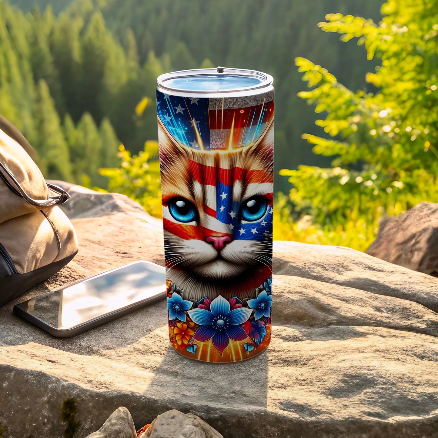 Cat face with US flag on patriotic tumbler with flowers and mountains background.