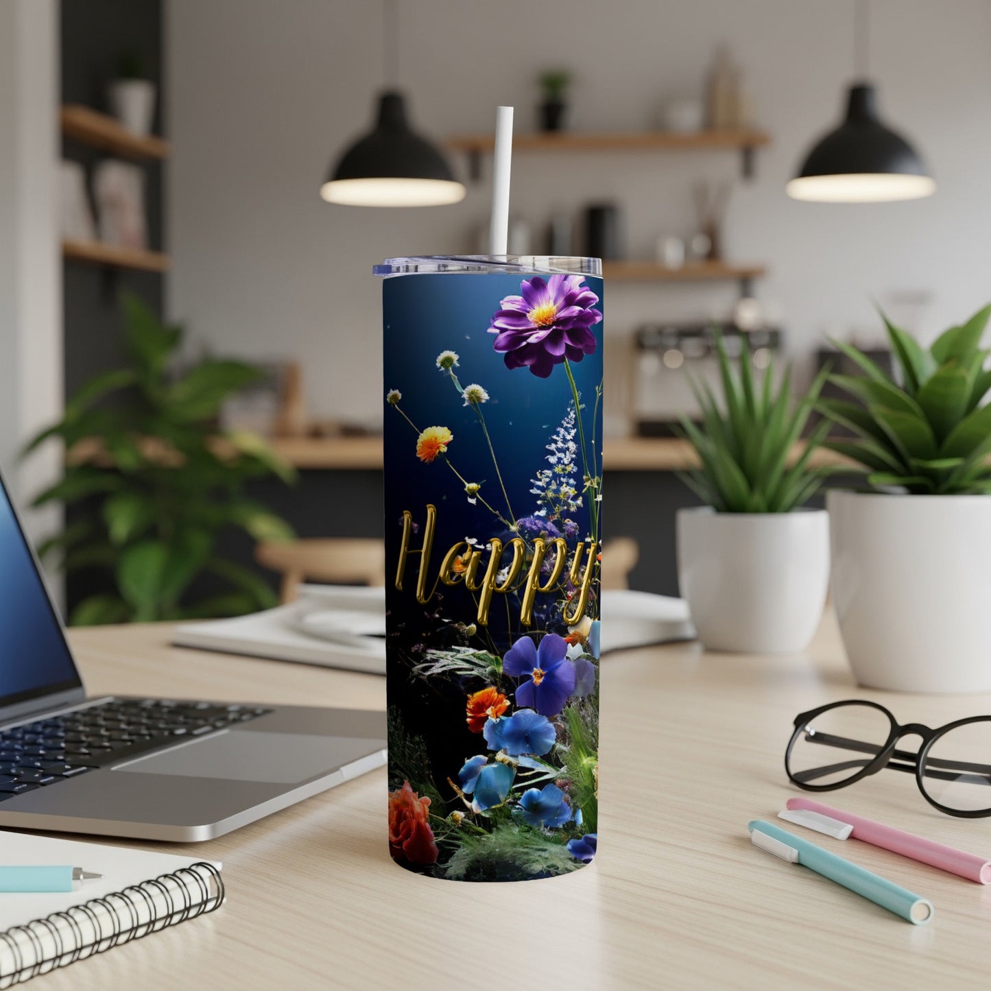 Tumbler with "Happy" text and colorful floral design, placed on a desk.