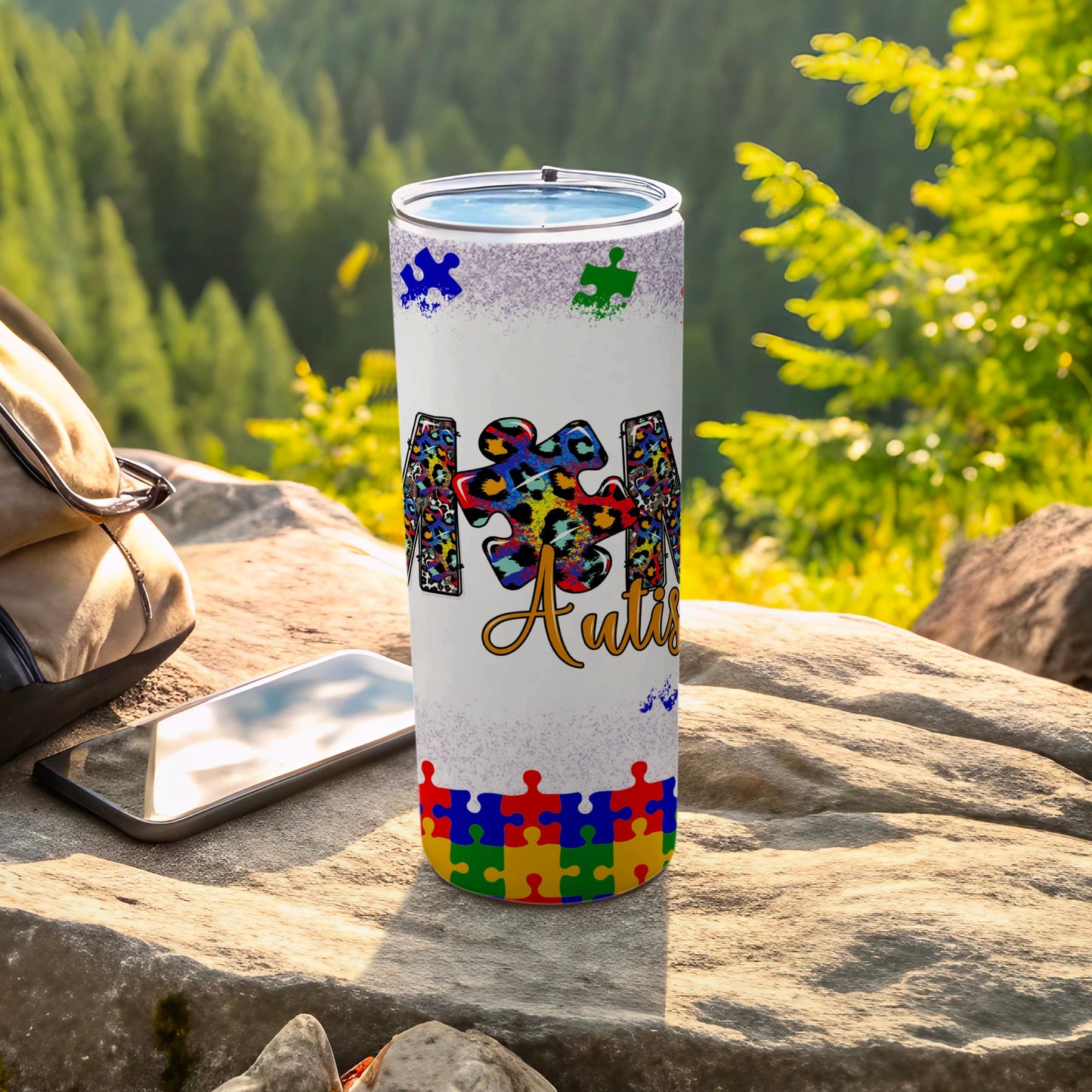 White tumbler with colorful puzzle pieces and "Autism" text.