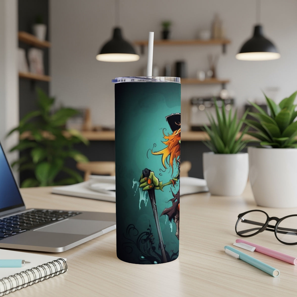 Tall tumbler with a cartoon scarecrow design on a teal background.