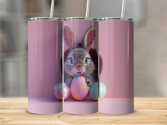 Pink tumbler with cute Easter bunny and painted eggs.