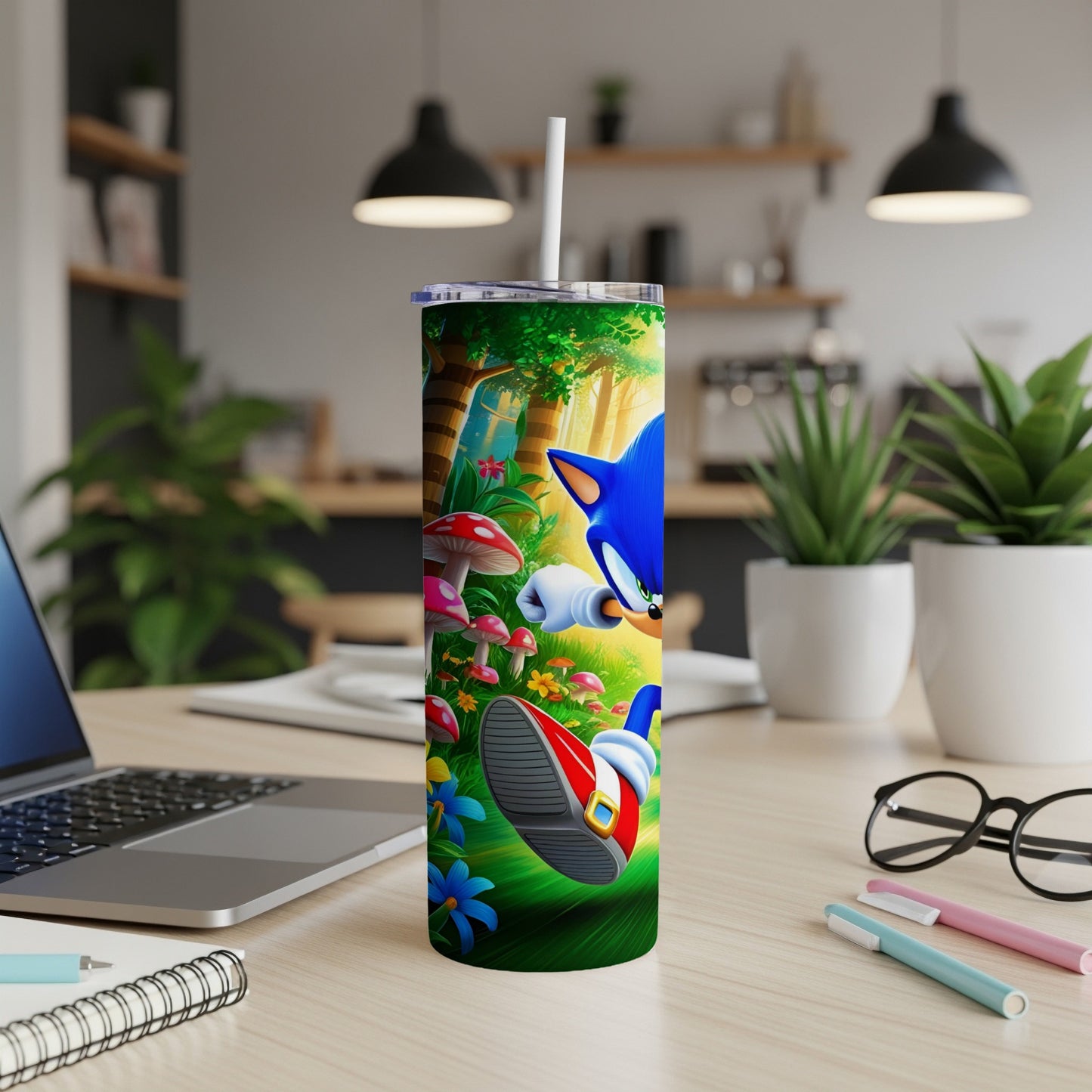 Sonic the Hedgehog runs on a desk beside a laptop and pens.
