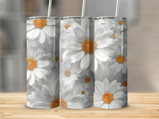 Three tumblers with a white daisy floral pattern on a wooden surface.