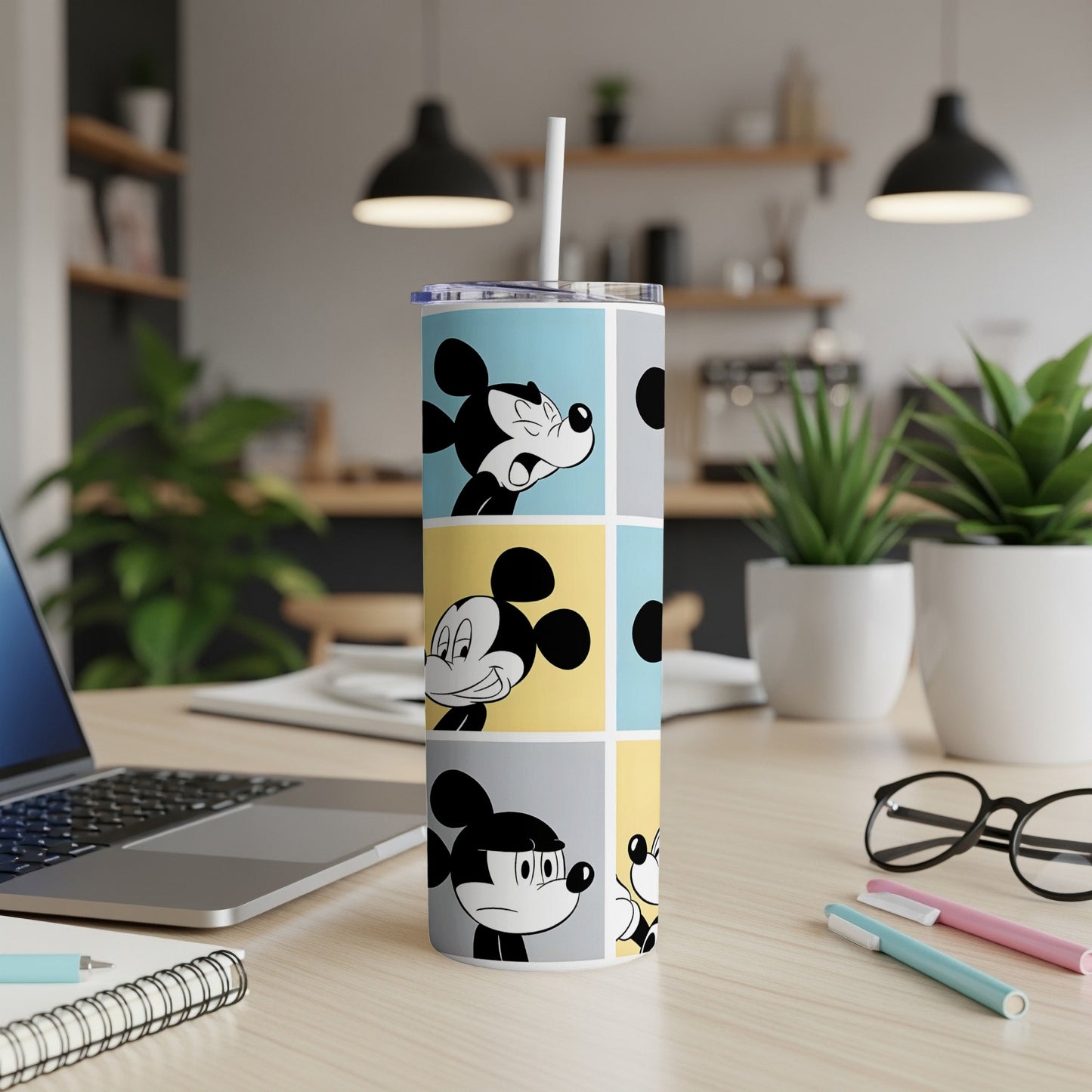 Mickey Mouse faces in blue, yellow, and grey comic panels on a skinny tumbler.