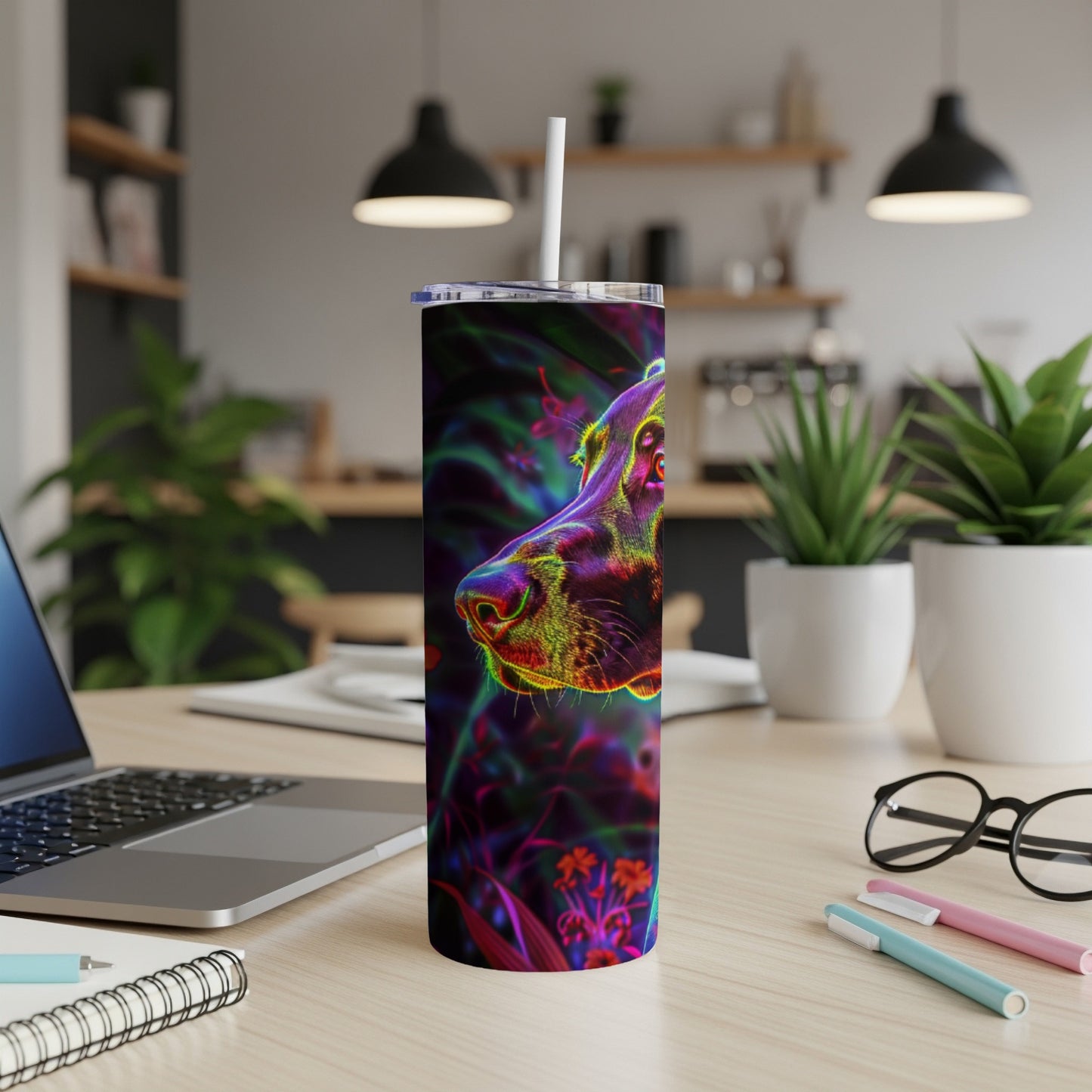 Neon dog portrait on a tumbler with a straw, on a desk.