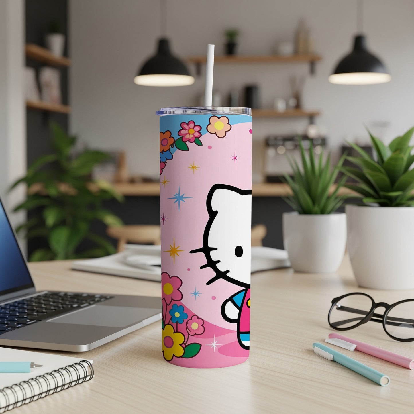 Pink Hello Kitty tumbler with flowers and a white straw.