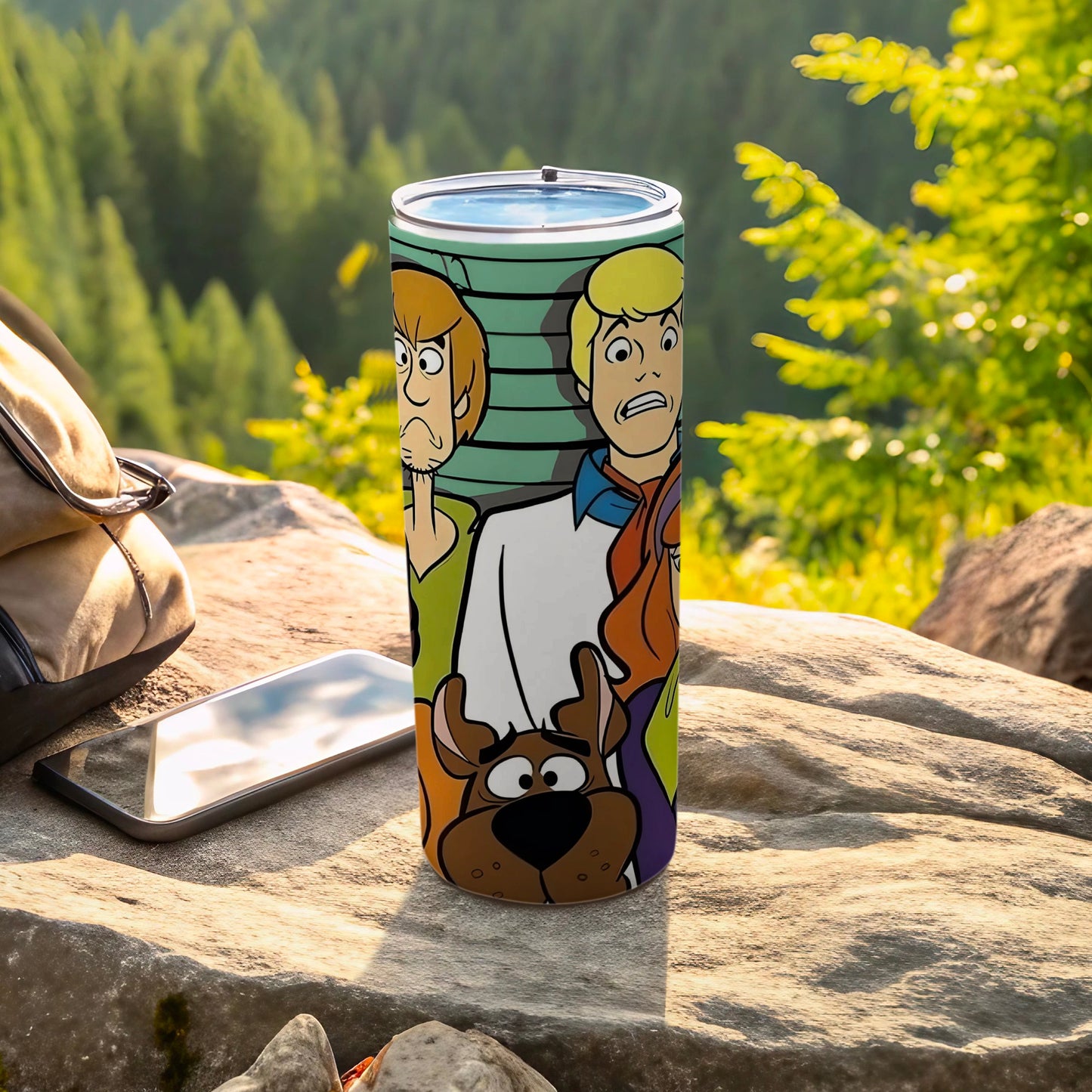 Scooby-Doo characters on a stainless steel tumbler, outdoors.