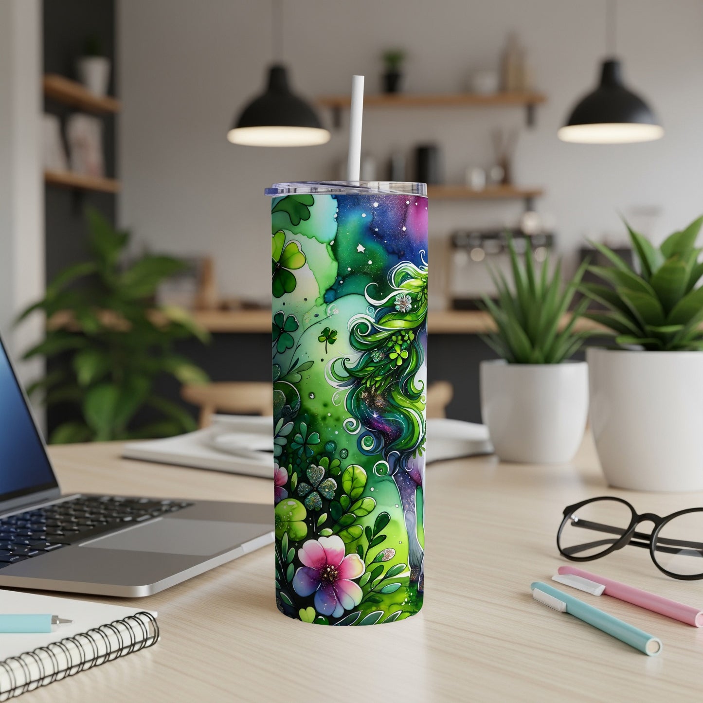 Green mermaid-like figure with flowers and shamrocks on a speckled tumbler.