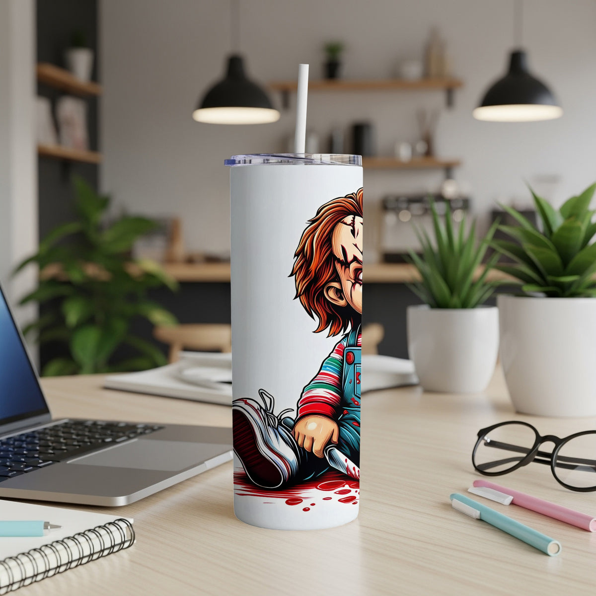 White tumbler with Chucky character artwork, holding a knife and sitting in blood.