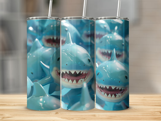 Three tall tumblers with cartoon shark faces, white straws.