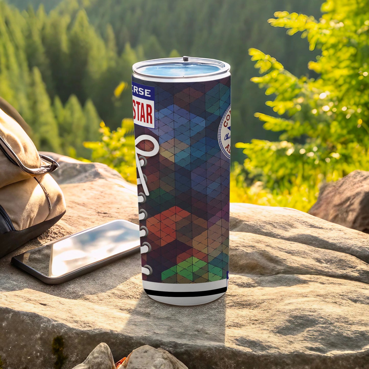 Converse tall tumbler with geometric pattern and logo on outdoor rock surface.